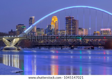 A Long Exposure of the Blue Lowry Bridge Compressed with the Minneapolis Skyline during a Winter Twilight Hour