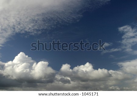 View of white puffy clouds against a blue sky