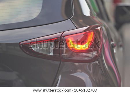car rear light on real traffic road