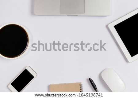 White Office desk table with laptop,smartphone and coffee cup and accessories. Business desk with a keyboard, mouse and pen on white table. Top view of workplace