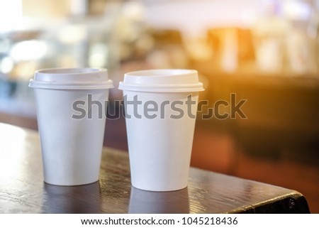 Take away, hot beverage coffee cup on the table in coffee shop.
