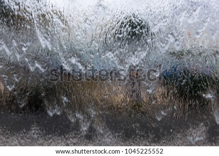 Waterfall glass wall decoration. Grey background texture, blurred, defocused concepts