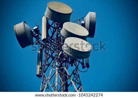 Cellphone tower with microwave dishes isolated unique stock photograph