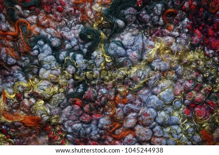 Texture colored felted fabric of dyed sheep's wool and viscose. Handmade