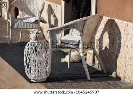 white wicker chairs on the street