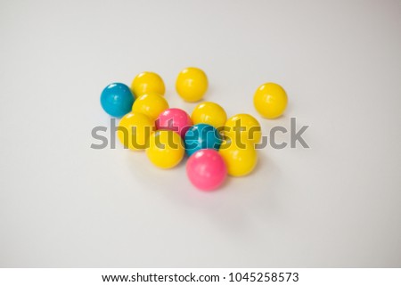 Colorful gumballs on a white background with selective focus.