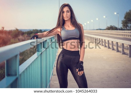 Woman resting after sports training outdoors.
