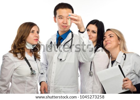 a group of young girls watching the result of the reaction of the drug in a test tube, under the guidance of a mentor Asian appearance