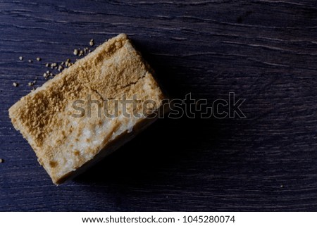 Napoleon cake with on a dark  wooden background, selective focus, top view. Photo with text area for design.