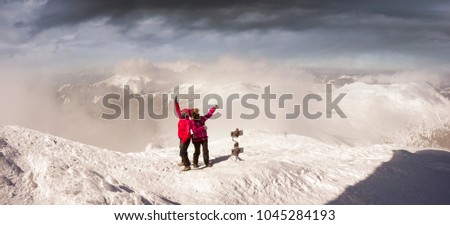 Commercial group of sports girls climbed to the top in the Carpathians and are happy with the beautiful weather taking pictures against the background of the winter observatory