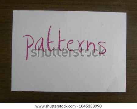 Text patterns hand written by red oil pastel on white color paper