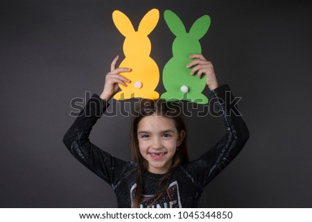cute happy little girl with easter bunnies