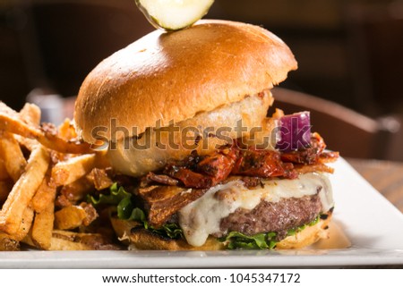 Burger with Onion ring, sun dried tomato & cheese