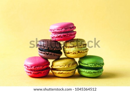 Pyramid of colorful, bright, traditional French Sweet macaroons on retro-vintage background
