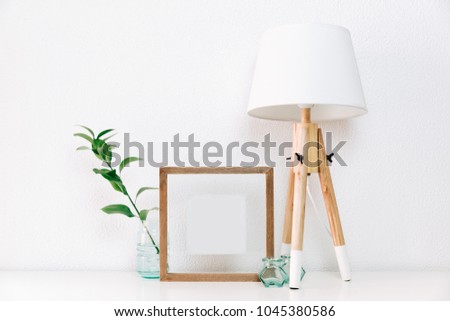 Frame poster mock up with green plant in vase and Nordic decorations. Minimal Scandinavian background 