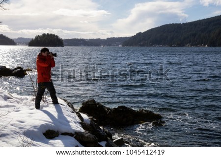 Photographer taking pictures of the beautiful landscape from Twin Island in Indian Arm, North of Vancouver, British Columbia, Canada.