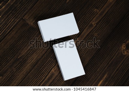 Blank business cards on wooden working table with copy space for add text ID. and logo, business company concept idea.