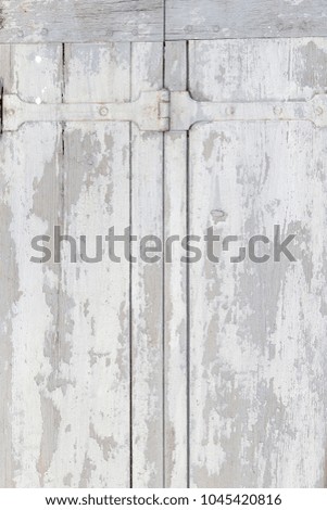 Row of ancient white weathered window shutters