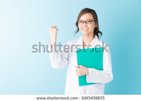Young attractive asian woman in a white coat,file,