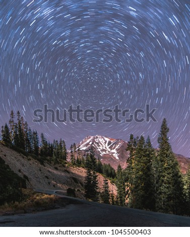 A long exposure captures the star trails around the north star over Mount Shasta