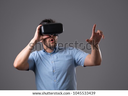 Bearded young man wearing virtual reality glasses. Virtual reality experience. New technologies in business