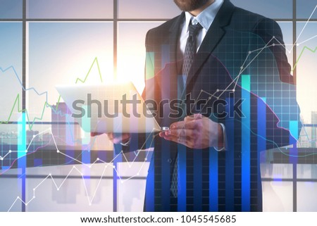 Communication and profit concept. Businessman using laptop on abstract office interior background with forex chart. Double exposure 