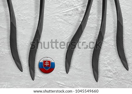 Slovak puck and five sticks on the ice of the hockey arena. Concept, hockey