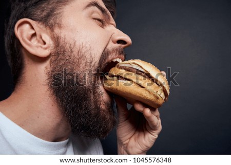 man eats a hamburger, harm to the body                               