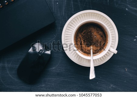 cup of coffee in the workplace. dark background. life style.