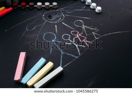 drawing of the family. Chalk board . children's creativity .