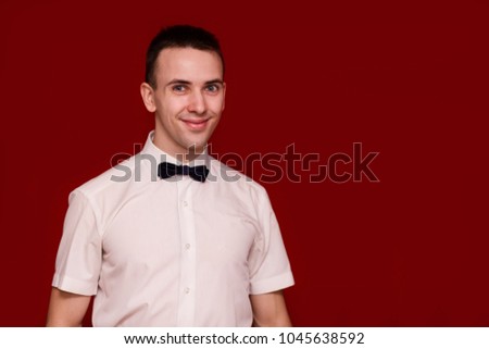 Happy man in white shirt isolated on red background. Photo for business projects, product presentation. Image with copy space isolated on red
