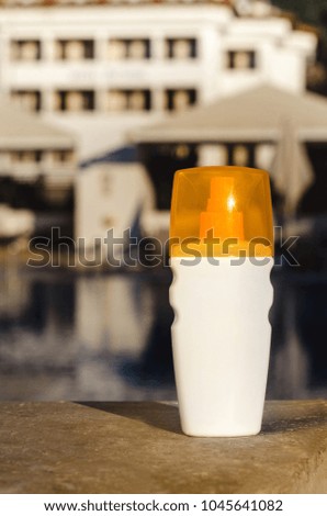 Sun protection cream on water background. Skin care concept sunscreen spray bottle lotion cosmetic products.