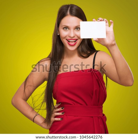 Happy Young Woman Holding Blank Placard against a yellow background