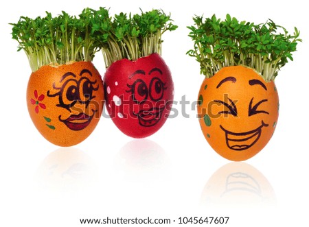 Handpainted Easter eggs with funny happy smiling faces with cress like hair. Handmade in multicolored patterns. Eggs look at other foreign individuals standing out surprised and terrified egg. 