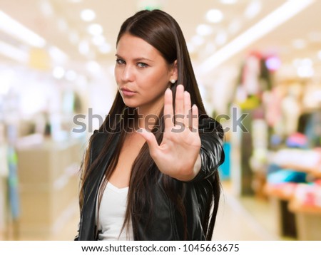 Young Woman Showing Stop Hand Gesture at a mall