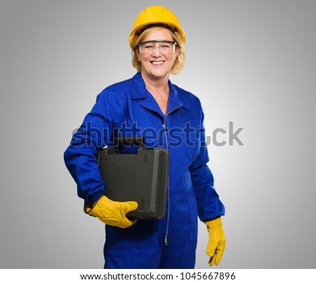 Portrait Of A Senior Technician On Grey Background