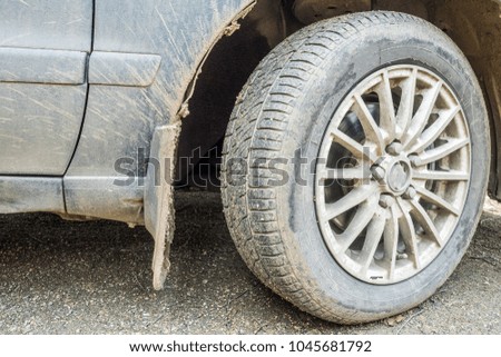 dirty wheel and car after village road.