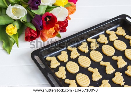 Traditional shortcrust easter cookies spring colorful tulips bouquet.