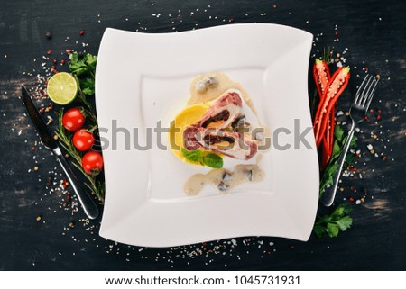 Chicken rolls with bacon and cheese on the plate. On a wooden background. Top view. Copy space.