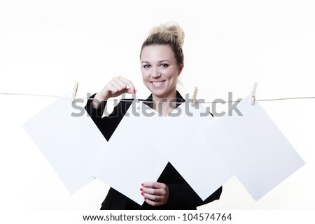 business woman hanging out blank piece of paper on a washing line using wooden pegs