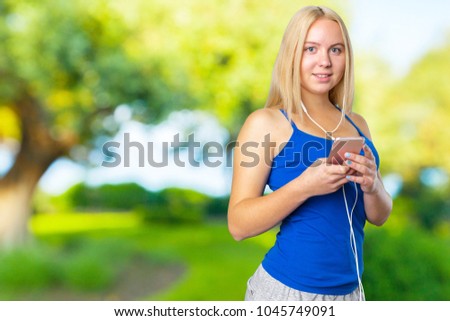 Portrait of a happy girl listening music