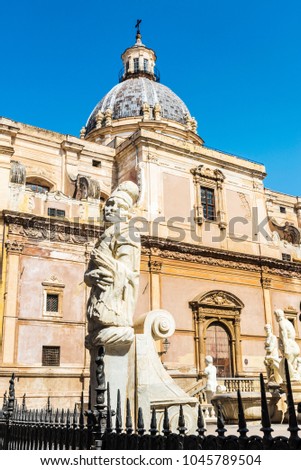 The Praetorian Fountain (Fontana Pretoria) with the dome of Santa Caterina in the background is a monumental fountain that represents mythological figures and animals in Palermo, Sicily, Italy