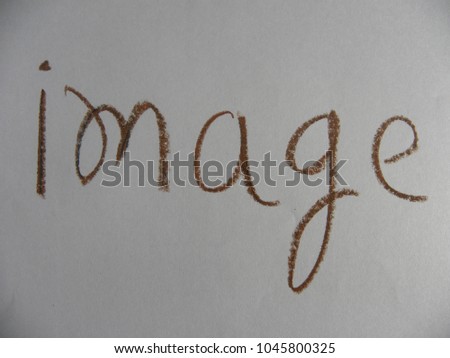 Text image hand written by brown oil pastel on white color paper