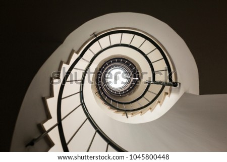 Spiral Staircase photographed upwards. Indoors. Architecture and design. Royalty-Free Stock Photo #1045800448