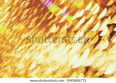 Abstract xmas Gold sparkles or glitter lights. Christmas festive gold background. Defocused bokeh  particles. Template for design
