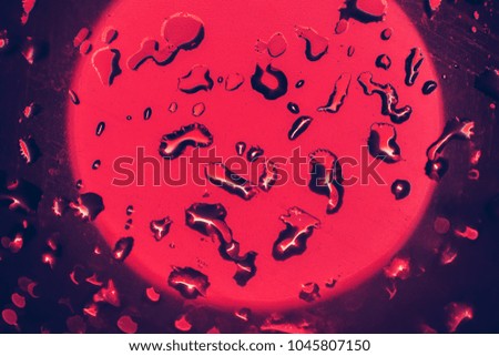 Abstract background of red water drops light bokeh circles. Bright round defocused lights. Can use for poster, website, brochure, print.