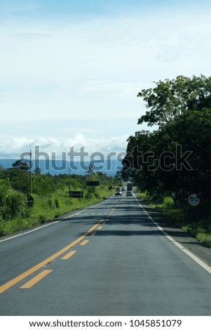 Road that connects Cuiaba, the capital of Mato Grosso State and the city of Chapada dos Guimaraes, Brazil. Greens and rock formations.