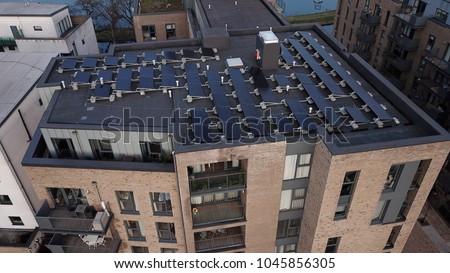 Aerial drone image of solar panels on the roof of a high rise building in London England.