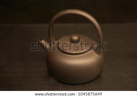 Clay ceramic traditional teapot in brown tone. Using for the traditional method of Chinese tea-making. The teapot is perhaps the most important element in this process.