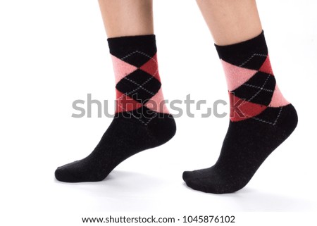 Side view of beautiful human foot dressed in new nice and soft natural cotton fabric blank sock isolated on abstract white background. Wearing and sport clothes concept. Detailed closeup studio shot.